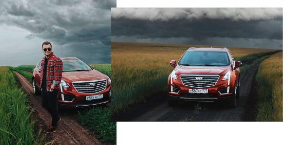 Евгений Фист и Cadillac XT5 на фоне пасмурного неба в поле